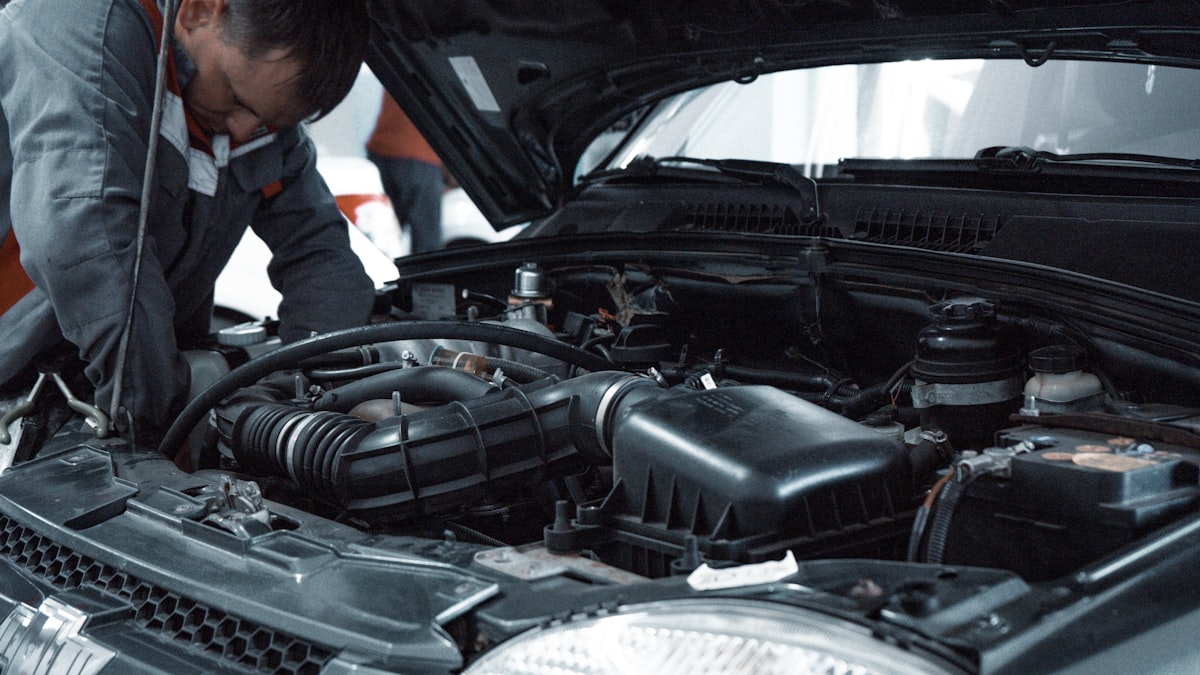 Wartungsarbeiten am Motorraum eines Pkw